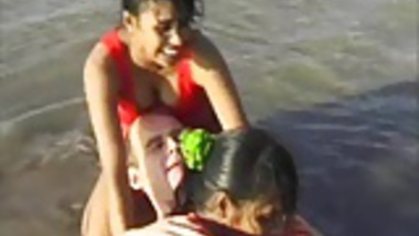 2 Indian girls with white guy in beach have fun blowjob..