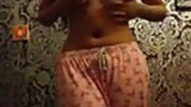 Skinny Indian woman strips in her bedroom.